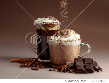 Hot chocolate and coffee with whipped cream sprinkled with chocolate crumbs. 126717698