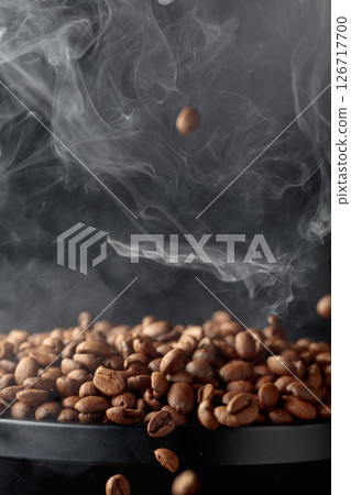 Steaming coffee beans in movement. 126717700