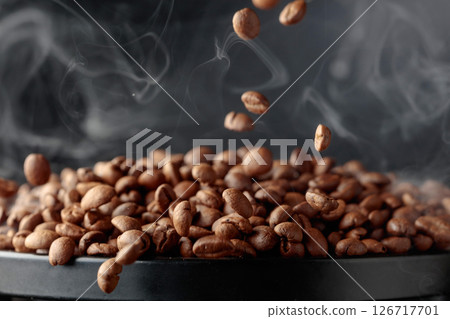 Steaming coffee beans in movement. 126717701