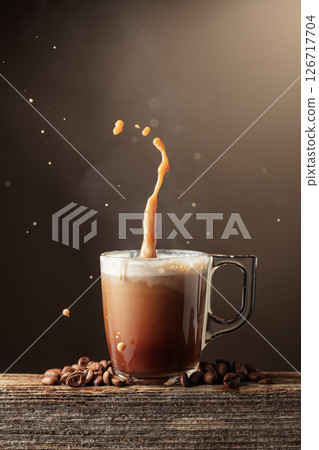 Coffee and chocolate drink with cream on a brown background. 126717704