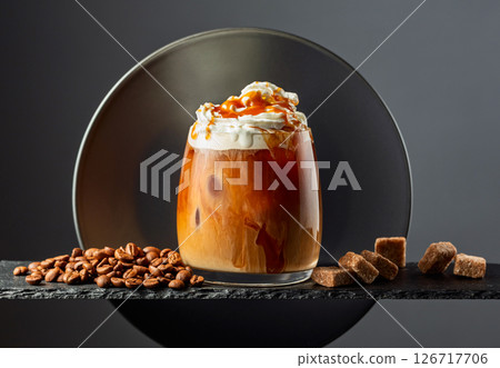 Iced coffee with whipped cream and caramel sauce. Iced coffee with whipped cream and caramel sauce. 126717706