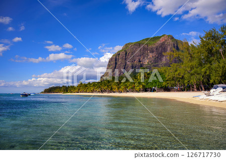 Tropical beach with boats, palm trees, and Le Morne Brabant mountain, Mauritius Tropical beach with boats, palm trees, and Le Morne Brabant mountain, Mauritius 126717730