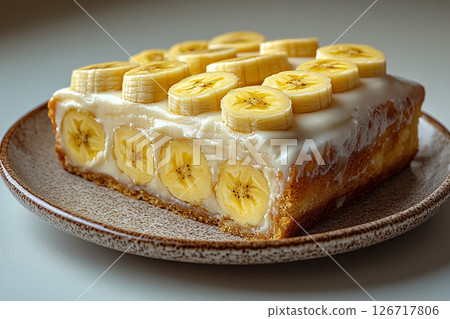 Sweet bake. Banana dessert in Yellow tones on dessert stand with soft lighting. 126717806