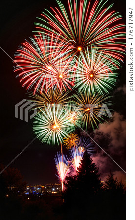 Vibrant fireworks bursting in night sky, celebration of joy 126717942