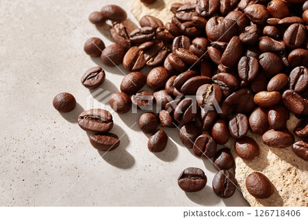 tempting coffee beans in the industrial corner on a cream background tempting coffee beans in the industrial corner on a cream background 126718406