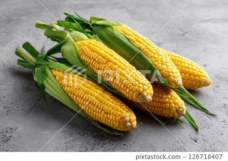 tempting corn in the minimalist corner on a light gray background tempting corn in the minimalist corner on a light gray background 126718407