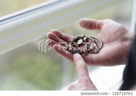 Man pointing on the oxidated parts of jewellery. Closeup, selective focus. Man pointing on the oxidated parts of jewellery. Closeup, selective focus. 126718761