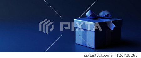Close-up of elegant blue gift box with satin ribbon on dark gradient background. Soft studio lighting. Luxurious and festive atmosphere. Perfect for celebrations, branding, or holiday promotions 126719263