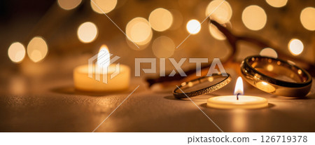 Elegant wedding rings shining by candlelight, love and commitment Elegant wedding rings shining by candlelight, love and commitment 126719378