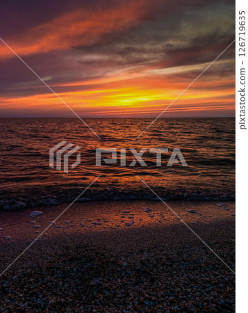 Picturesque seascape illuminated by golden rays of sun at sunset. Picturesque seascape illuminated by golden rays of sun at sunset. 126719635