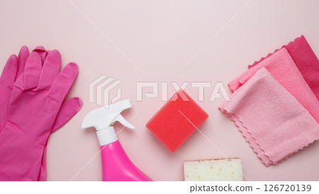 Household cleaning and hygiene concept. Pink cleaning supplies including rubber gloves, spray bottle, sponge, microfiber cloths Household cleaning and hygiene concept. Pink cleaning supplies including rubber gloves, spray bottle, sponge, microfiber cloths 126720139