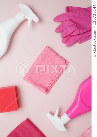 Household cleaning and hygiene concept. Pink cleaning supplies including rubber gloves, spray bottle, sponge, microfiber cloths Household cleaning and hygiene concept. Pink cleaning supplies including rubber gloves, spray bottle, sponge, microfiber cloths 126720144