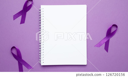 Purple Epilepsy Awareness Day, purple ribbon held, symbol of support. Mock up notebook 126720156