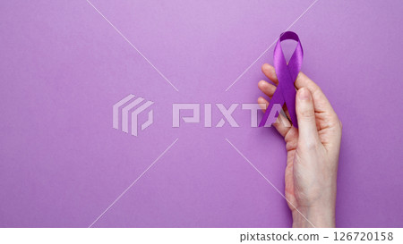 Purple ribbon held, symbol of support. Purple Epilepsy Awareness Day Purple ribbon held, symbol of support. Purple Epilepsy Awareness Day 126720158