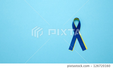 Symbolizing World Down Syndrome Day. A yellow and blue awareness ribbon 126720160