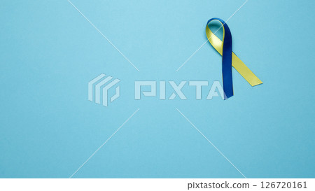 Symbolizing World Down Syndrome Day. A yellow and blue awareness ribbon 126720161