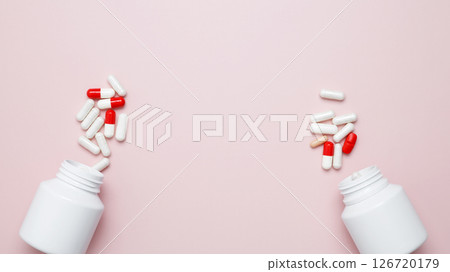 White bottles container with colorful medication capsules and tablets. Concept of healthcare and medicine 126720179