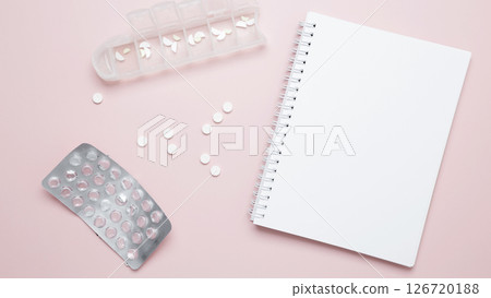 Concept of medicine, healthcare, and pharmaceutical industry. Blister of tablets and blank notebook 126720188