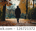 Senior woman walking with a cane in a park, highlighting mobility and independence in old age 126721372