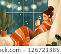Woman in cozy blanket sipping hot chocolate during peaceful mindful evening at home 126721385