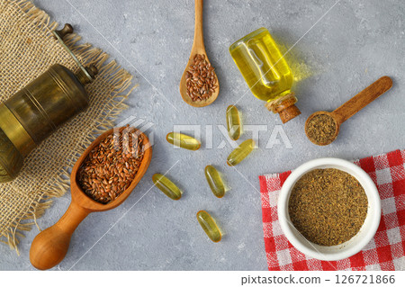 Flax seeds. Flaxseed powder in a wooden spoon. Standing on a Wooden background. 126721866