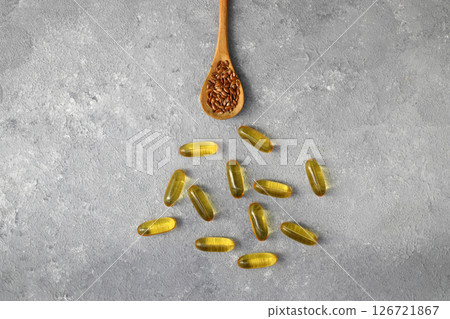 Flax seeds. Flaxseed powder in a wooden spoon. Standing on a Wooden background. 126721867