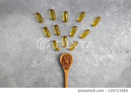 Flax seeds. Flaxseed powder in a wooden spoon. Standing on a Wooden background. Flax seeds. Flaxseed powder in a wooden spoon. Standing on a Wooden background. 126721868