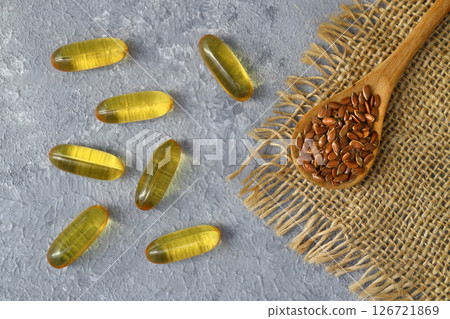 Flax seeds. Flaxseed powder in a wooden spoon. Standing on a Wooden background. Flax seeds. Flaxseed powder in a wooden spoon. Standing on a Wooden background. 126721869