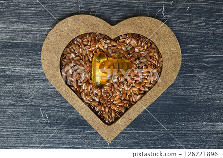 Flax seeds. Flaxseed powder in a wooden spoon. Standing on a Wooden  background. 126721896