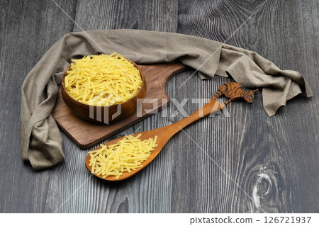 Handmade Turkish Noodles (Turkish Name: Eriste) in bowl. Erishte from Traditional Turkish Cuisine. Vermicelli on wooden background. 126721937