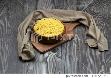Handmade Turkish Noodles (Turkish Name: Eriste) in bowl. Erishte from Traditional Turkish Cuisine. Vermicelli on wooden background. 126721939