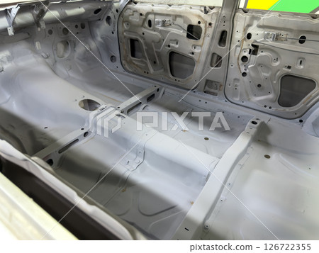 Restored car interior with visible tunnel reinforcement and detailed floorpan shaping, highlighting structural preparation for performance upgrades and racing modifications 126722355