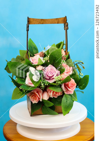 A fragrant bouquet of soap roses in a violin-shaped flowerpot is a unique gift for the holiday A fragrant bouquet of soap roses in a violin-shaped flowerpot is a unique gift for the holiday 126723492