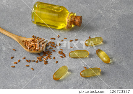 Flax seeds. Flaxseed powder in a wooden spoon. Standing on a Wooden background. Flax seeds. Flaxseed powder in a wooden spoon. Standing on a Wooden background. 126723527