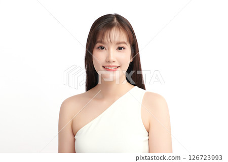 A beautiful young Asian woman with clean, fresh skin against a white background. Skincare, facial treatment, cosmetology, beauty, and spa. An elegant portrait of an Asian woman. 126723993