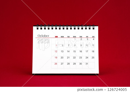 October 2025 Blank desk calendar on red background. 126724005