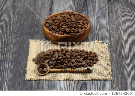 Wooden bowl with coffee beans on wooden background 126724200