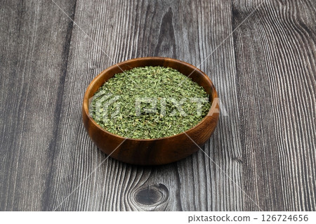 Dry mint in wooden spoon isolated on wooden background 126724656