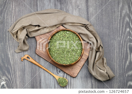 Dry mint in wooden spoon isolated on wooden background 126724657