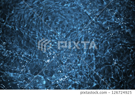 Blue water with ripples. Defocus blurred bleu clear calm water surface texture with splashes and bubbles. 126724925