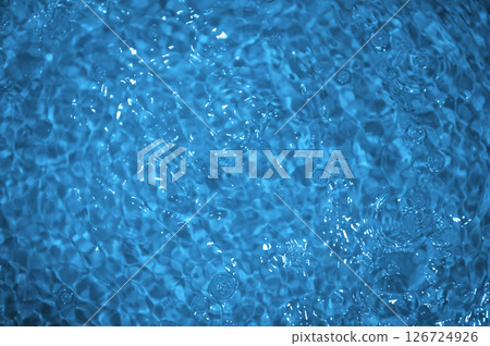 Blue water with ripples. Defocus blurred bleu clear calm water surface texture with splashes and bubbles. 126724926