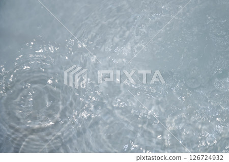 Blue water with ripples. Defocus blurred bleu clear calm water surface texture with splashes and bubbles. Blue water with ripples. Defocus blurred bleu clear calm water surface texture with splashes and bubbles. 126724932