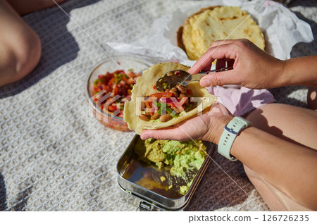 Family Creating Tacos on a Summer Picnic in the Mountains 126726235