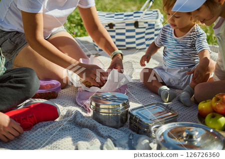 Family Enjoying a Summer Picnic Outdoors in the Mountains 126726360