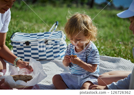 Family Picnic in Nature with Mother and Children on a Sunny Summer Day 126726362