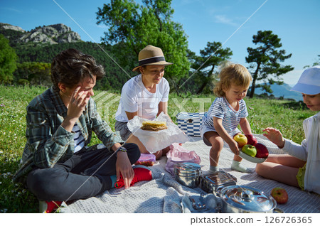 Mother Enjoying a Summer Family Picnic With Her Kids in a Beautiful Mountainous Setting 126726365