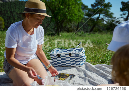 Mother Arranging Picnic Meal in Mountainous Area During Summer 126726368