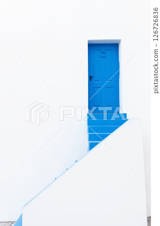greece fasade with white wall and blue door. Minimalistic light background 126726836