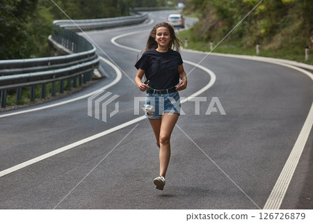 Woman running on a bendy road 126726879