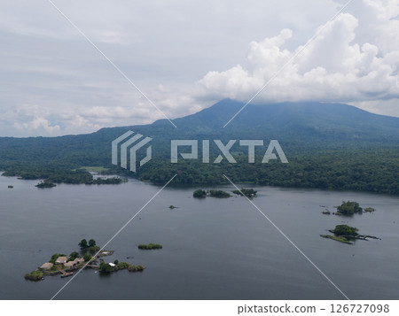 Small islands in lake on volcano background 126727098